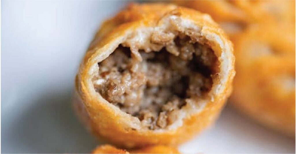 The insides of a delicious empanada, made with ground pork